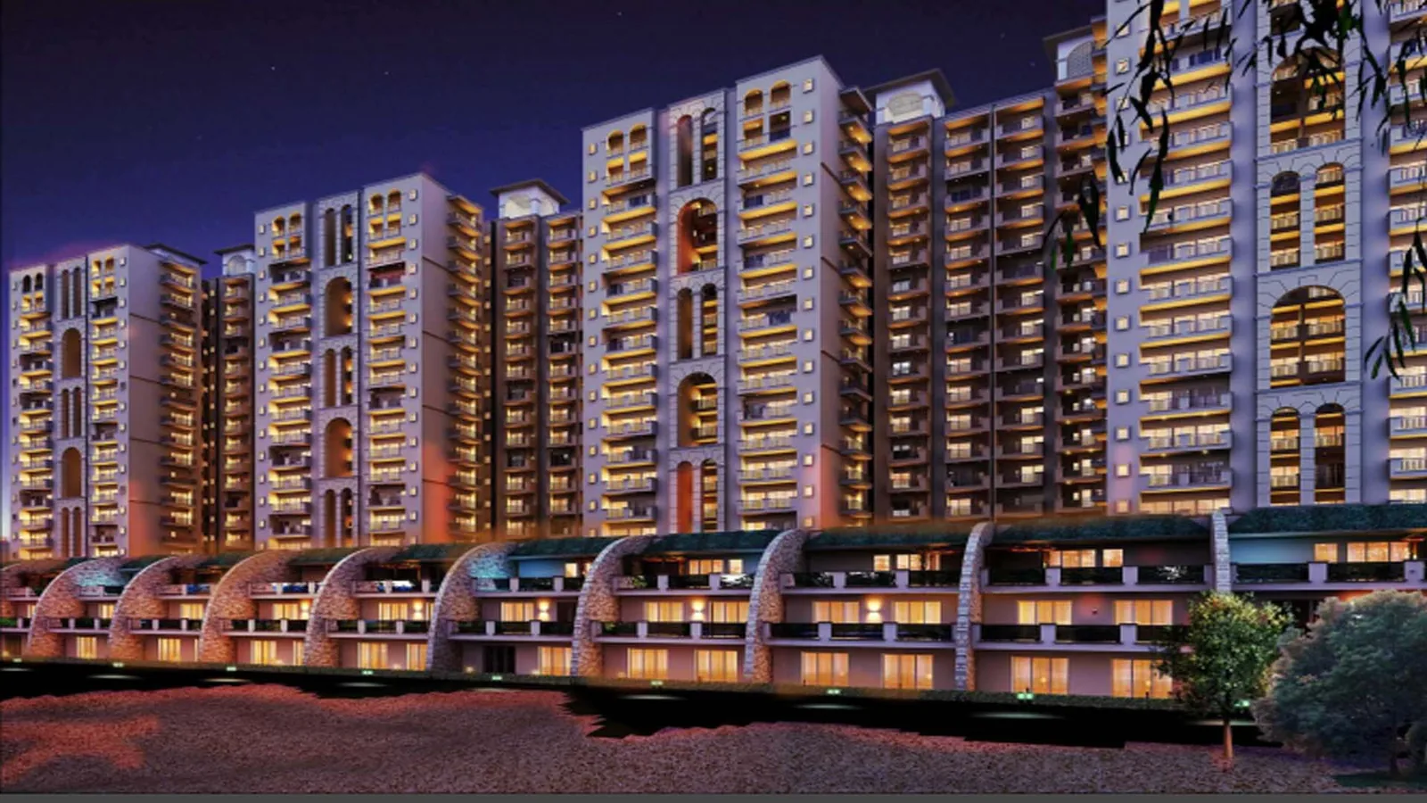 Antriksh Golf City towers lit at night above the arcade