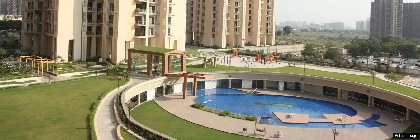 The pool and surrounding lawn at Gaur Saundaryam